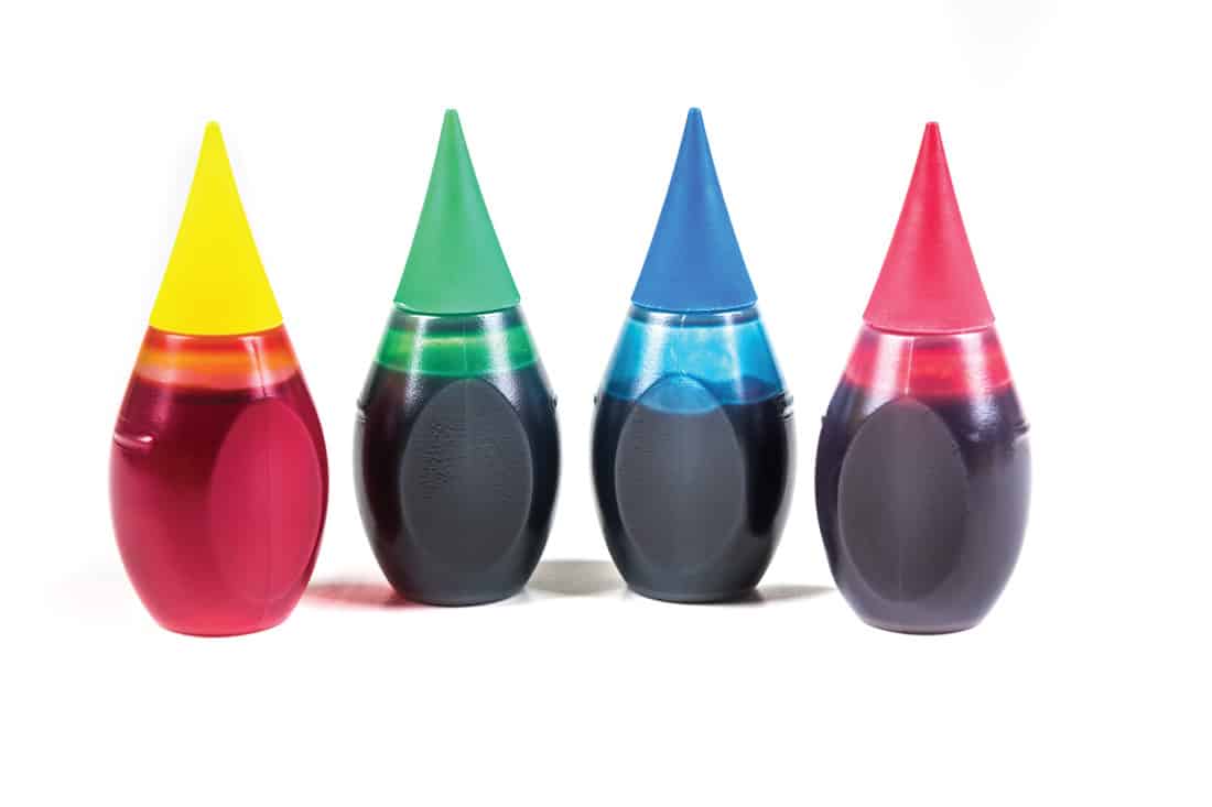 4 bottles of food coloring isolated on white background
