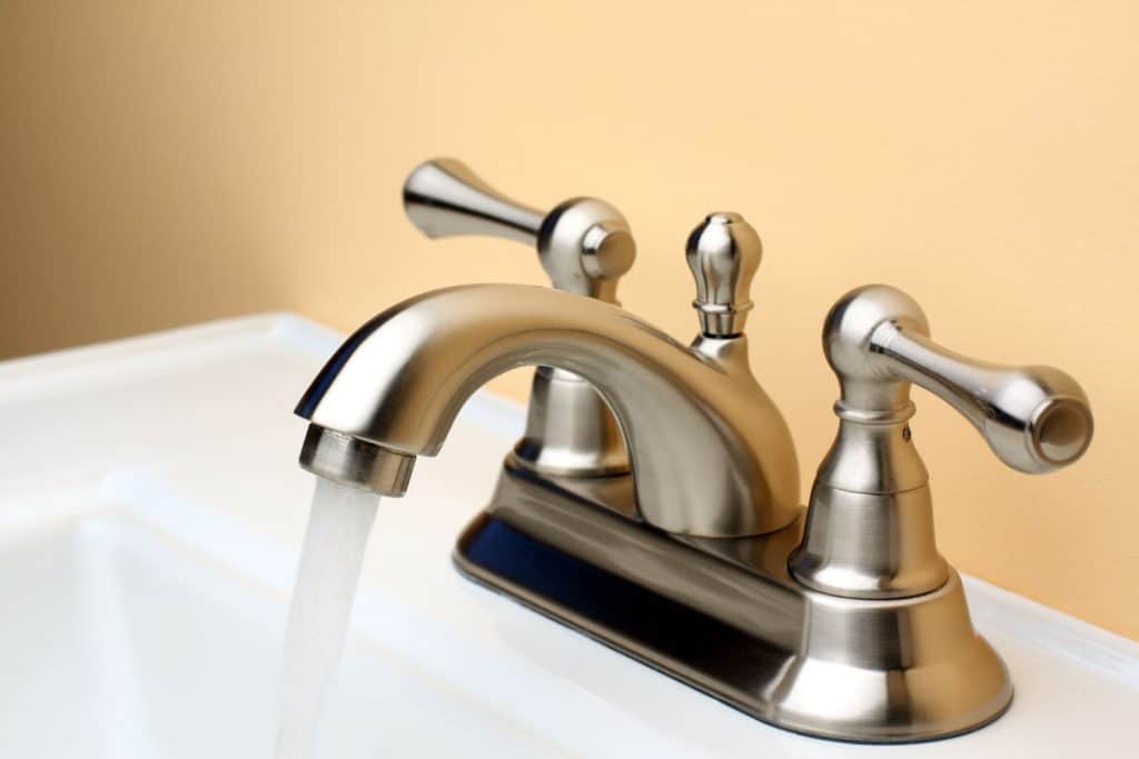 A brushed Nickle faucet with running water
