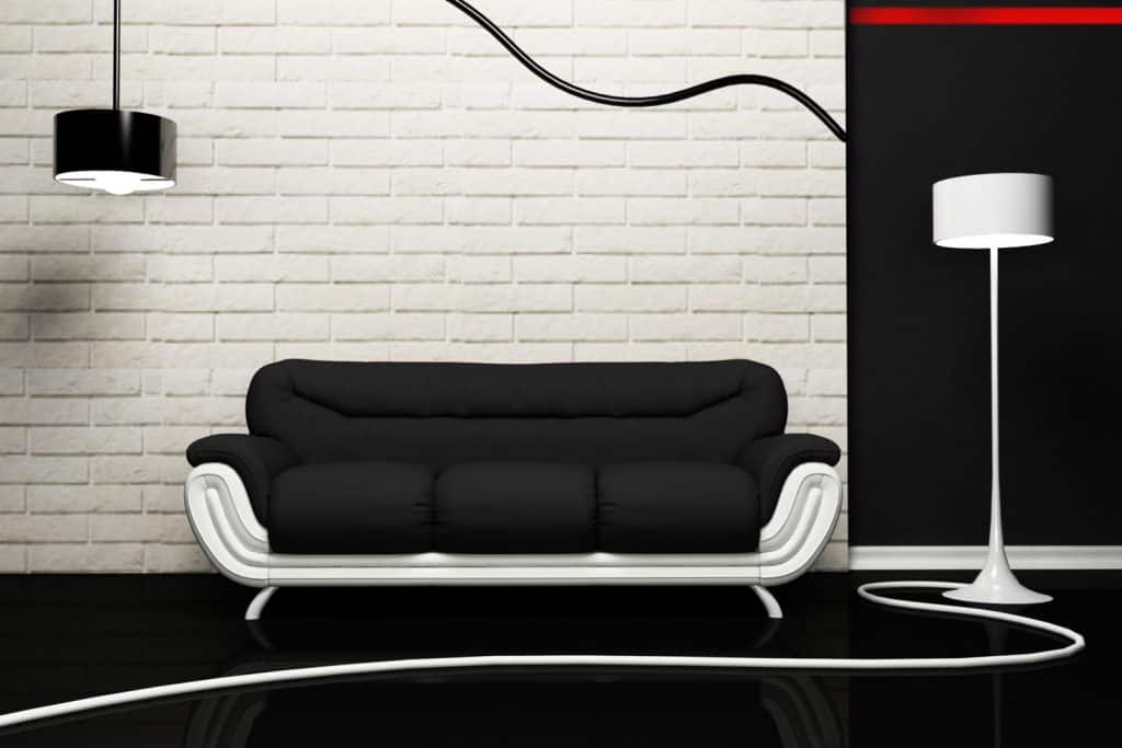 A dark sofa inside a minimalist themed living room