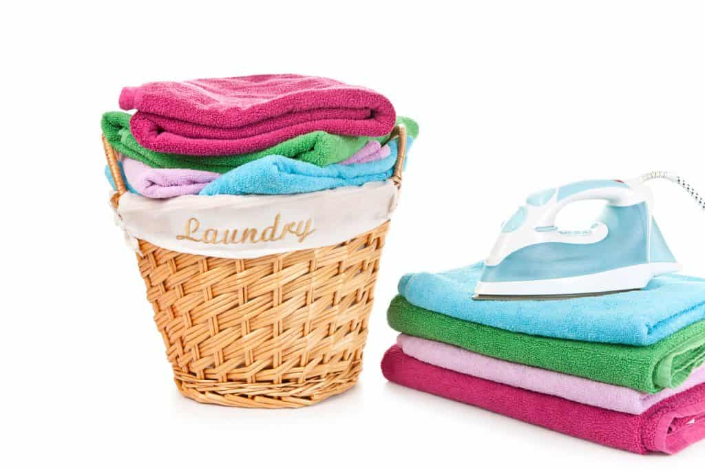 A laundry basket filed with newly cleaned and folded towels