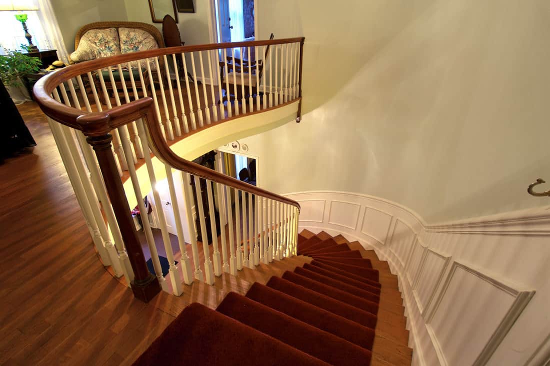 Modern house with a winding staircase, wooden stair railing and carpet flooring staircase, 16 Awesome Stair Trim Ideas