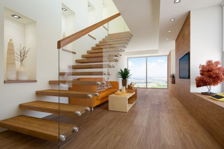 Rustic themed loft apartment with wooden flooring stairs with a bolted glass wall attached with a wooden railing, What Type Of Glass Is Used For Stairs?