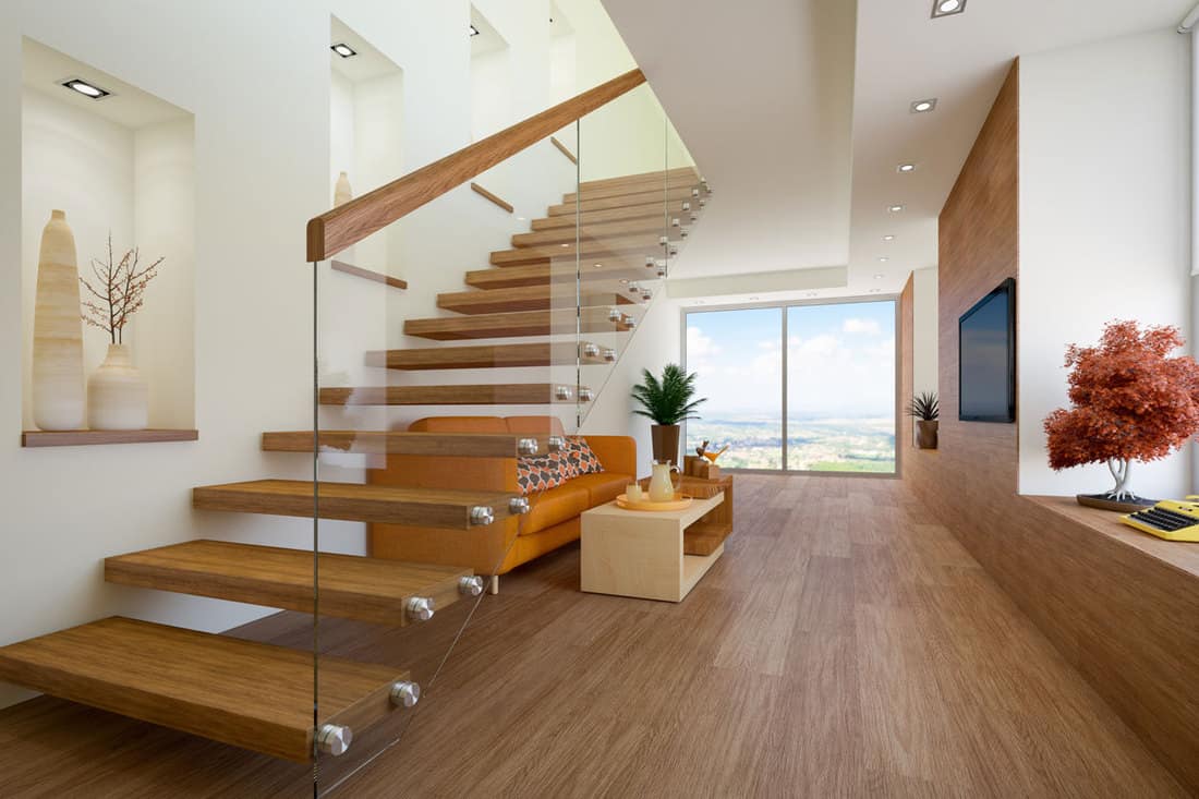 Rustic themed loft apartment with wooden flooring stairs with a bolted glass wall attached with a wooden railing, What Type Of Glass Is Used For Stairs?