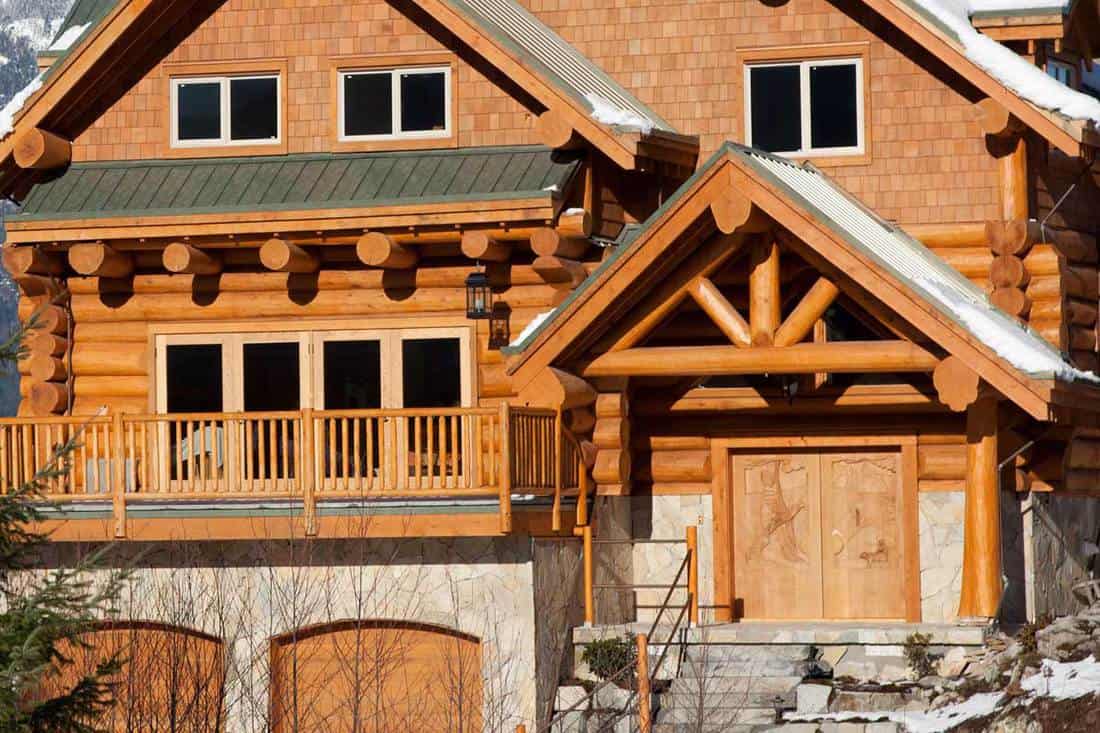 A west coast wooden house during winter in mountains, How Long Does Log Siding Last