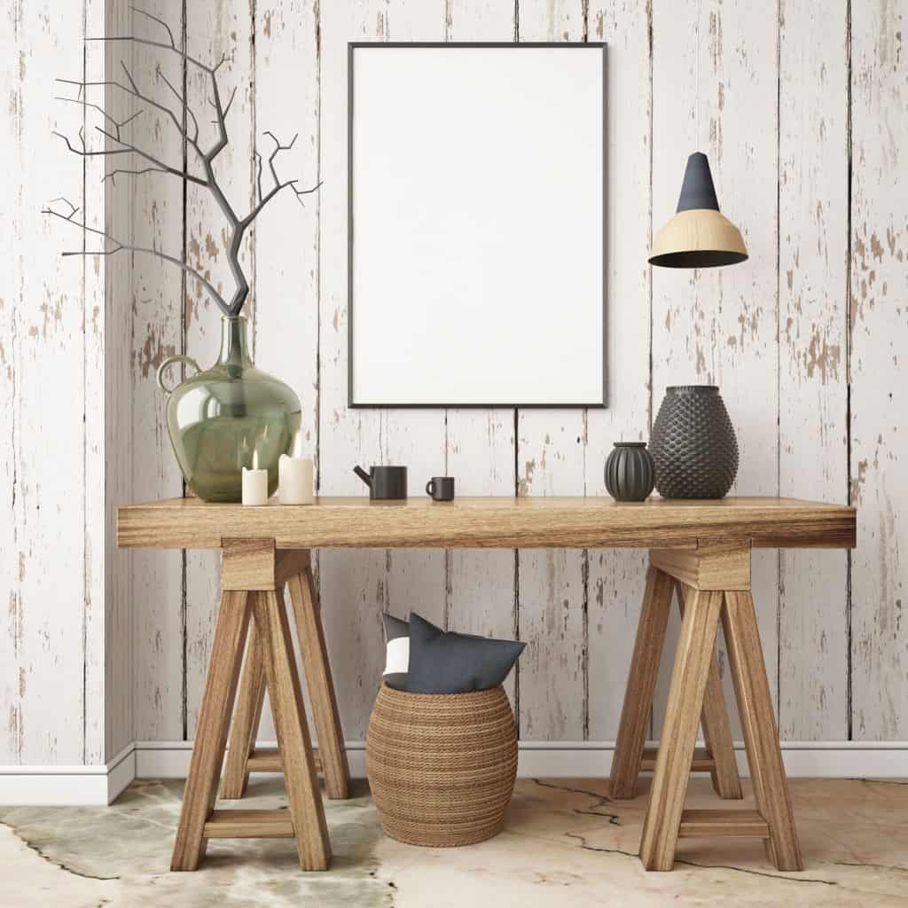 A wooden craftsman made console table with vase and a mock up picture frame on the wooden paneled wall