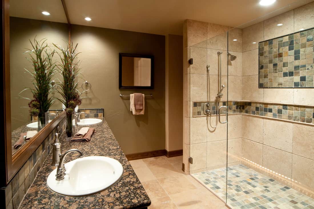 Bathroom with marble sink, shower and mirror.
