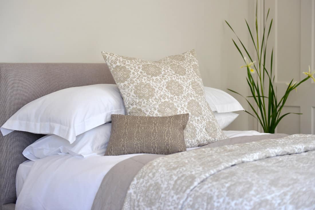 Bedroom setting with luxury pillows, shams and duvets