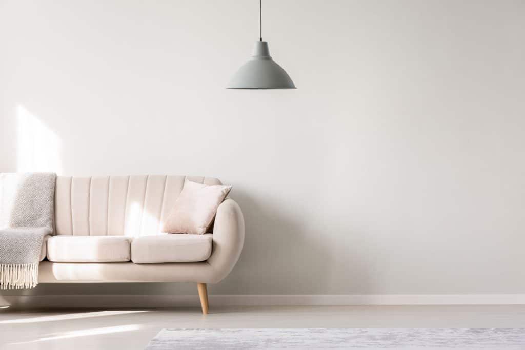 Beige loveseat sofa inside a beige living room