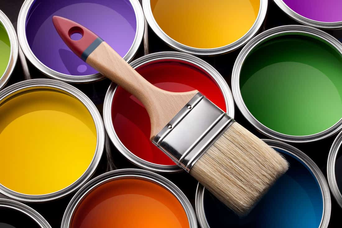 Colorful paint cans with brush, Enamel vs. Latex Paint: What Are the Differences?