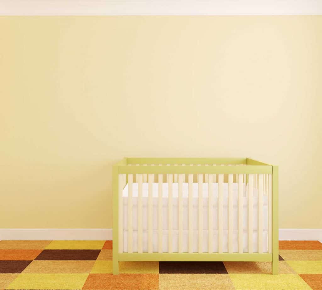 Crib near yellow wall