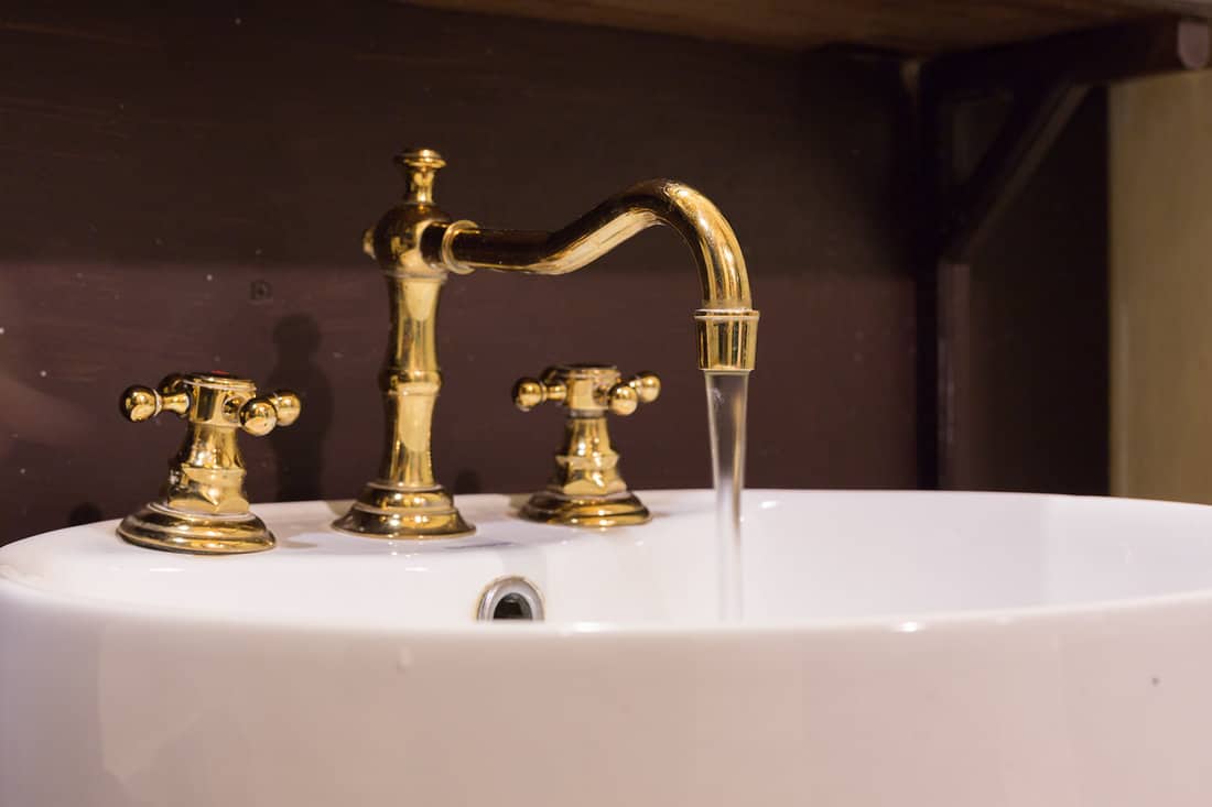 Gold faucet and washbasin design retro vintage decorated luxury interior bathroom
