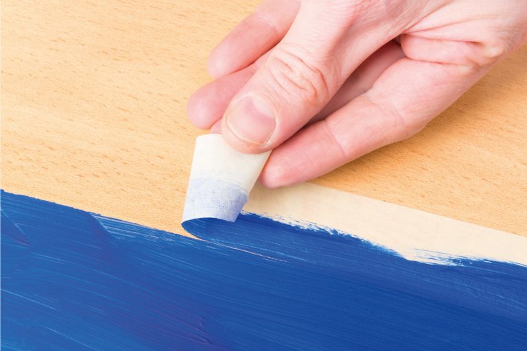 Hand removing masking tape also known as sticky tape, How To Paint With Sherwin Williams Emerald