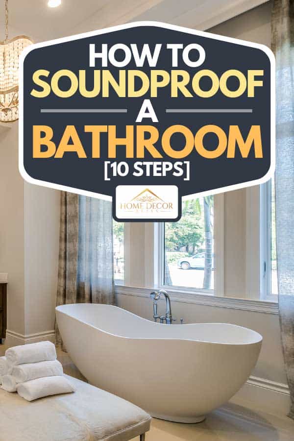 A freestanding tub and ottoman stool in center of bathroom, How To Soundproof A Bathroom [10 Steps]