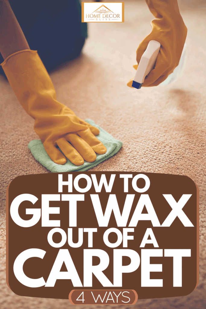 A woman wearing gloves and using a cloth together with a spray to remove wax on her carpet, How to Get Wax Out of a Carpet [4 Ways]