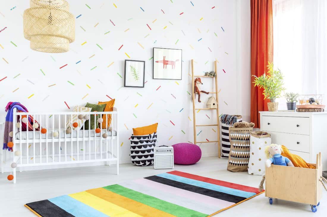Infant room in scandinavian style with white cot