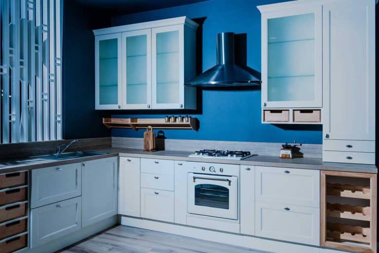 Interior of contemporary wooden kitchen with white furniture and blue walls, What Color Cabinets Go With Blue Walls?