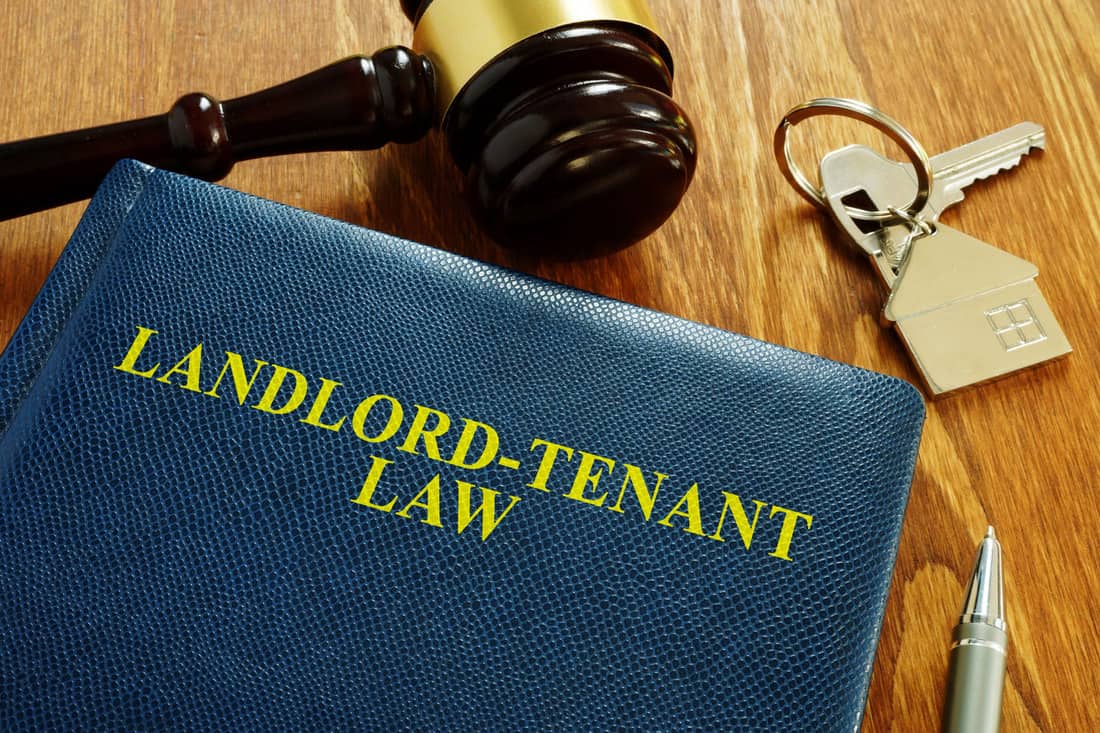 Landlord Tenant Law book and key from home.