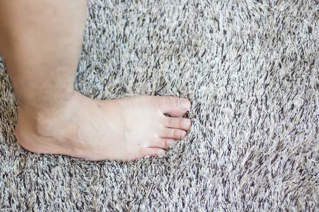 Male feet on carpet