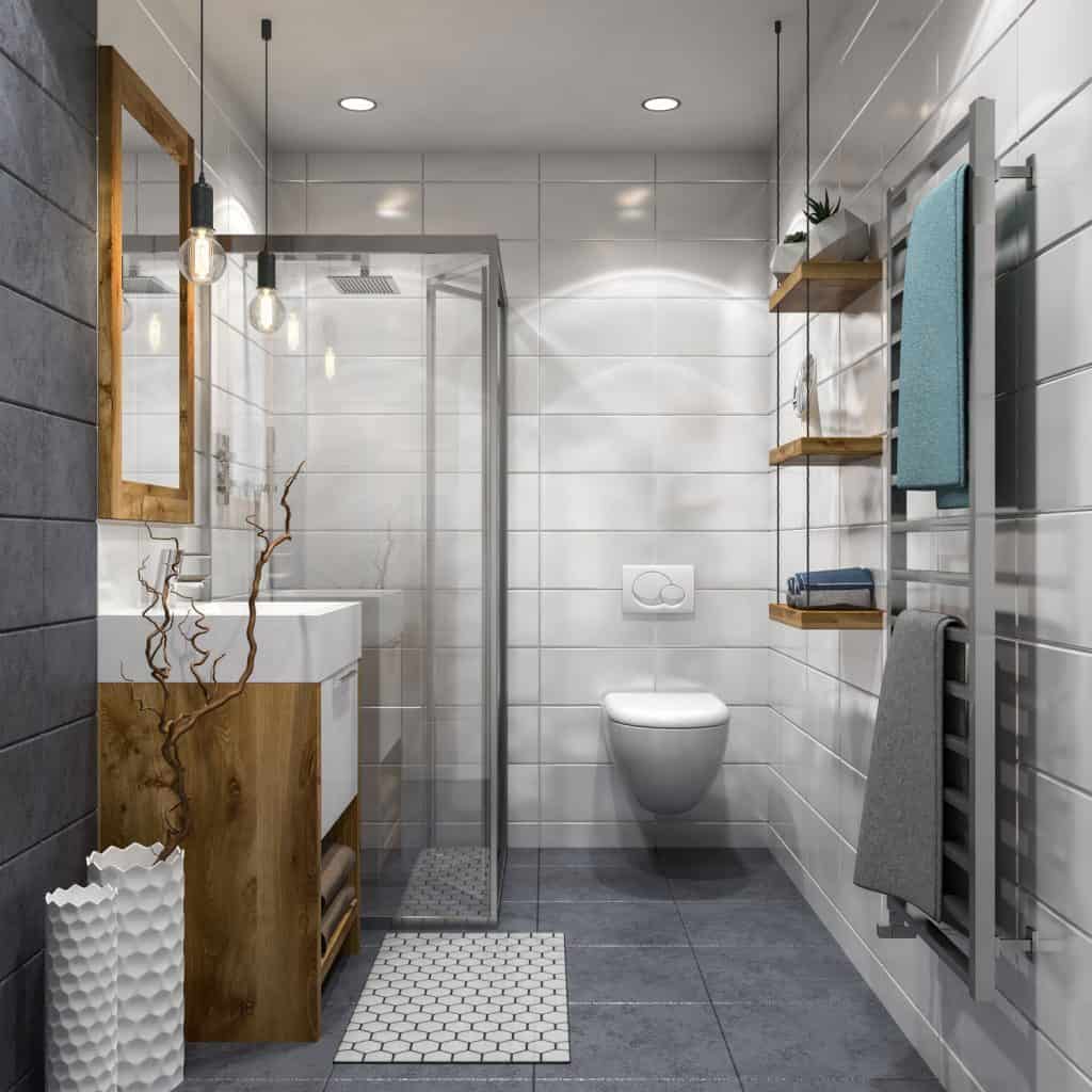Modern bathroom with a visible metal framed shower area, gray tiles, wooden paneled vanity area, and a metal framed towel hanging section