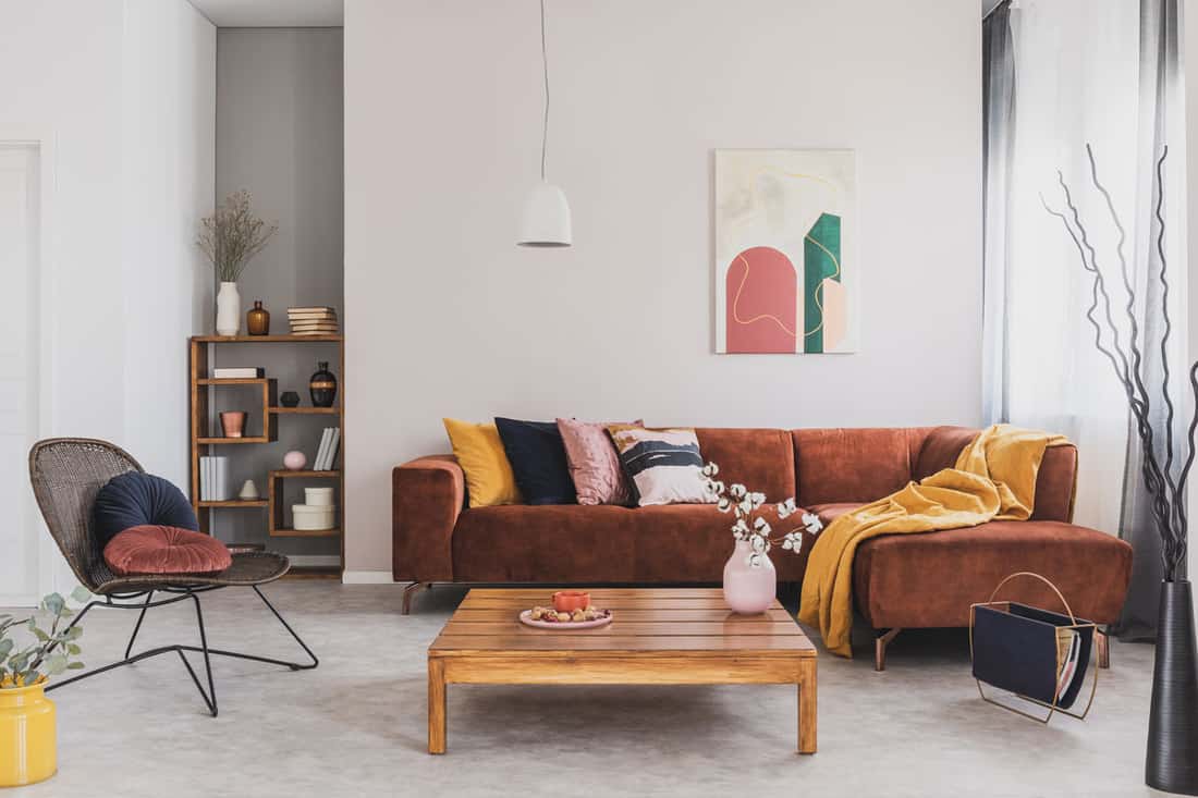 Modern contemporary living room with a brown sectional sofa, white painted walls, and a wooden coffee table, Should Sectional Pieces Really Match?