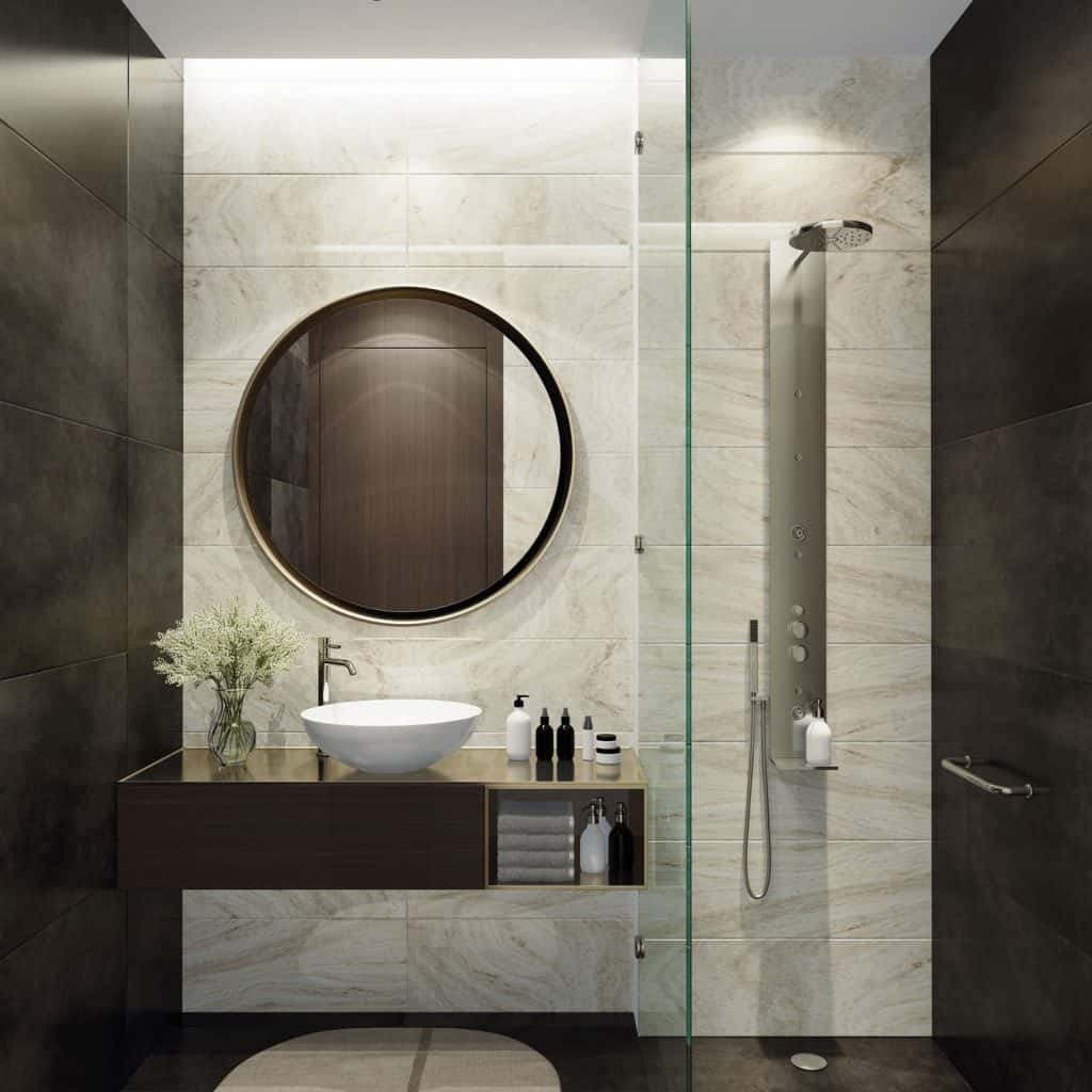 Modern contemporary themed bathroom with a round mirror and a brown colored vanity area