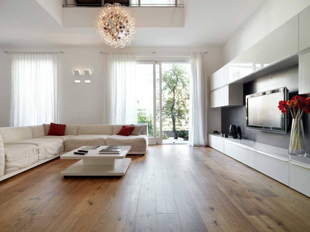 Modern living room with wooden floor and white corner sofa