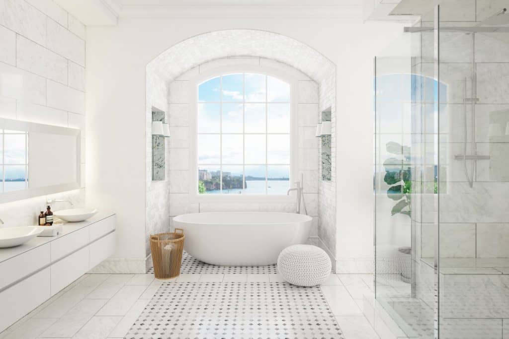 Modern white painted bathroom with a white flooring, white walls and a window with a panoramic view of the bay