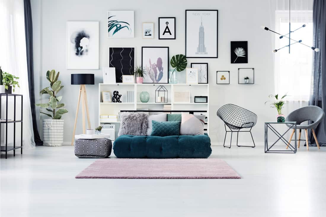 Scandi living room with posters and pink rug on the floor