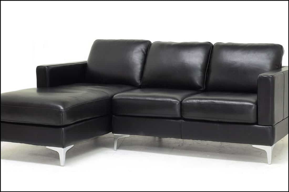 Sectional style sofa (2 seat sofa plus chaise) in black leather with metal legs