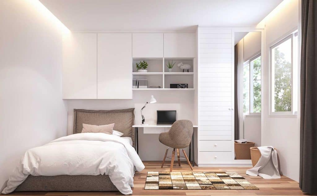 Teenage bedroom with wooden floor, white wall, brown bed and white cabinet