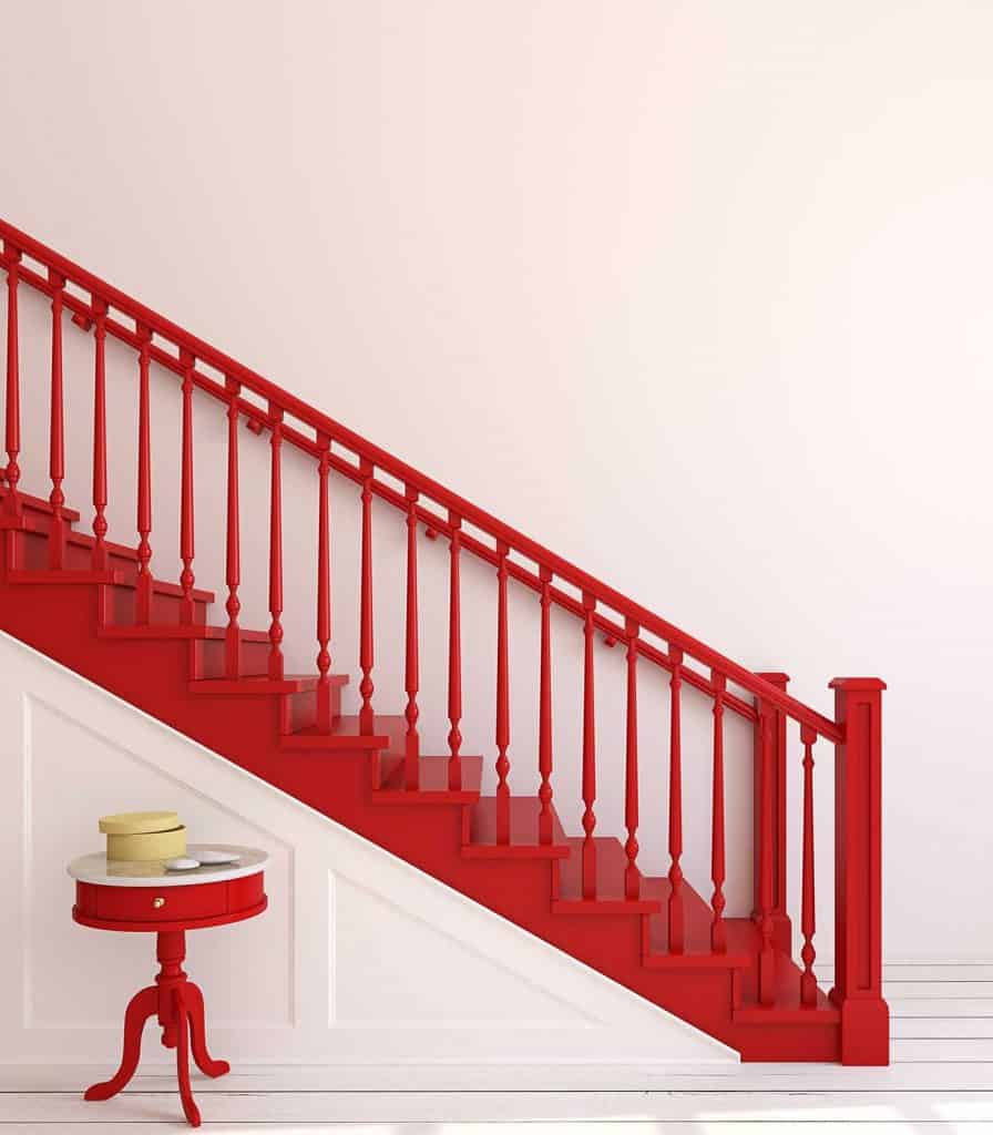 Wood stairway with red banisters and railings