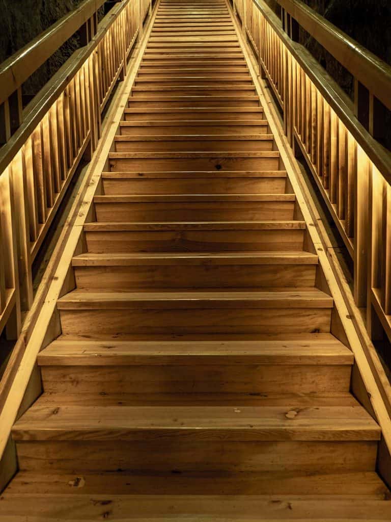 Wooden stairs with backlight from bottom till top