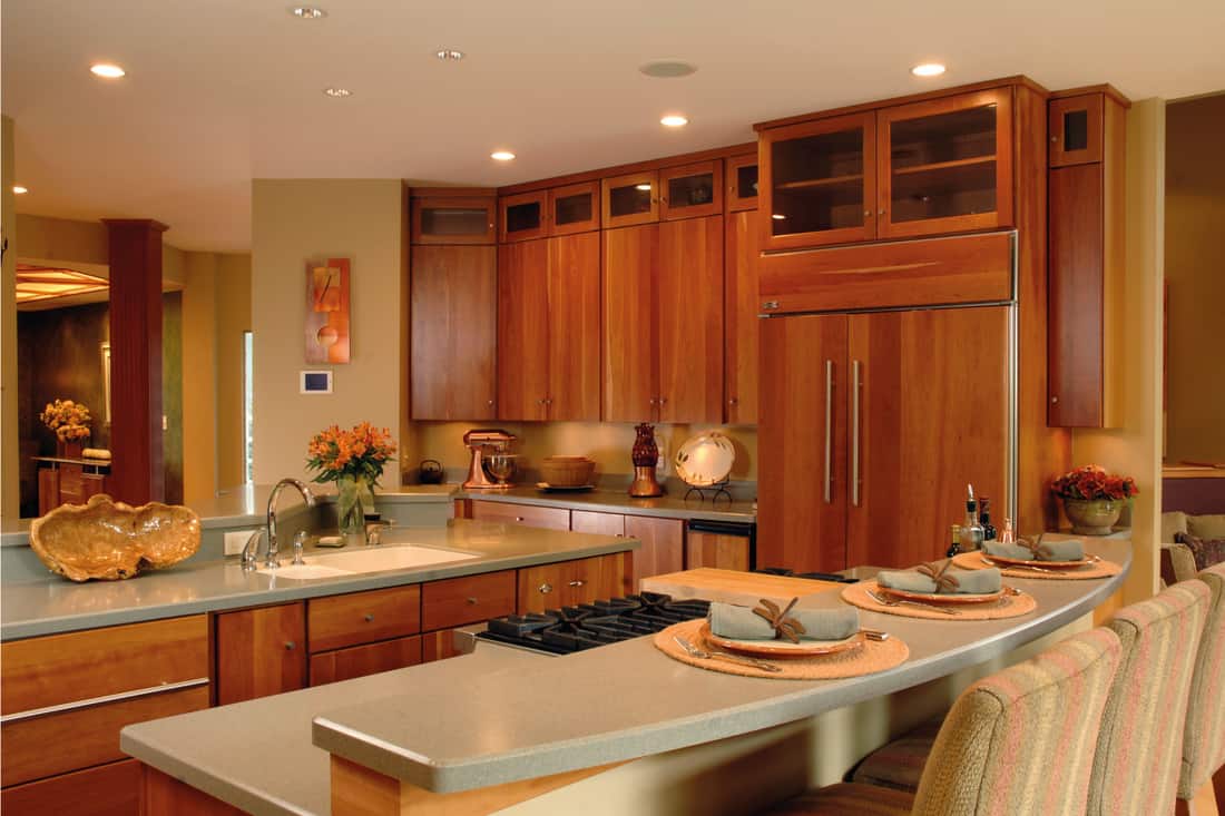 a new kitchen with contemporary design and cherry cabinets, beige furniture