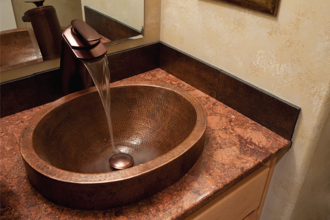 bronze bathroom sink in a hotel room