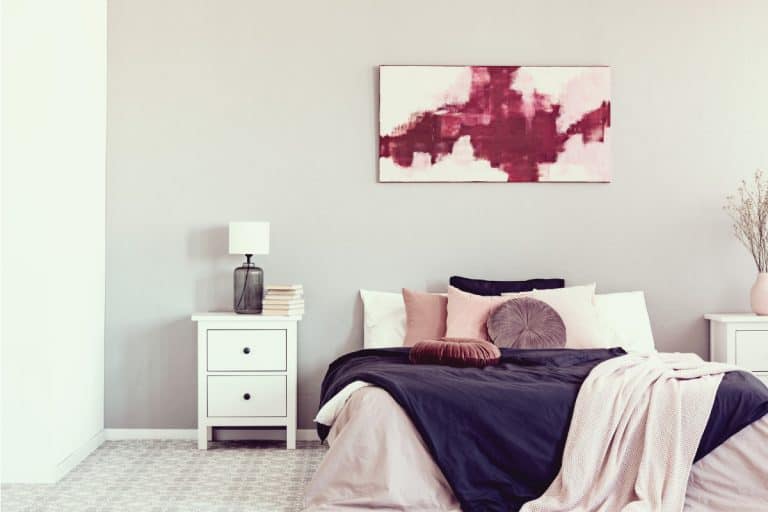 King-sized bed with cozy bedding and abstract painting on top, 11 Above-The-Bed Wall Decor Ideas