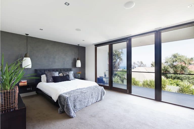 Large cozy bedroom with sliding glass doors leading to a patio, 9 Types Of Sliding Door Locks