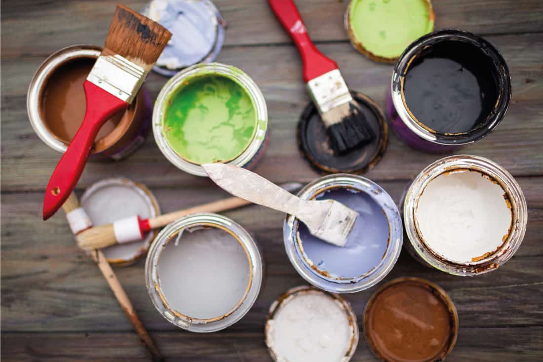 Open paint cans with paint brushes on top, How Long Does Sherwin Williams Paint Last?
