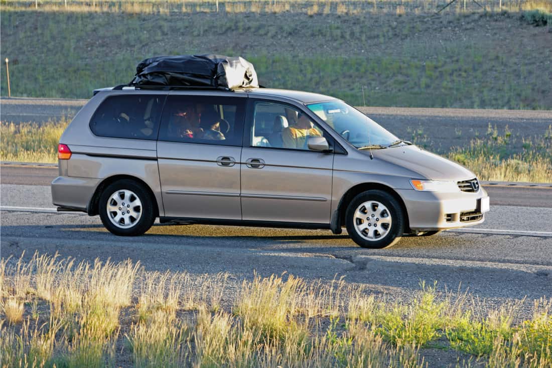 Silver gray minivan with family insidem running on the freeway,Can A Loveseat Fit In A Minivan Or An SUV?