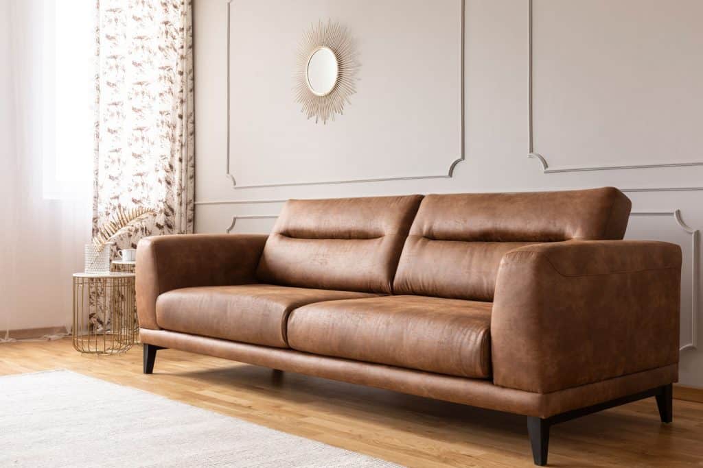 A contemporary living room with a dark brown sofa