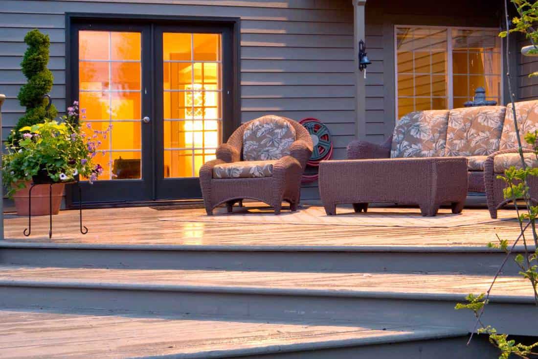 A deck with night window glow, 11 Awesome Deck Paint Color Ideas