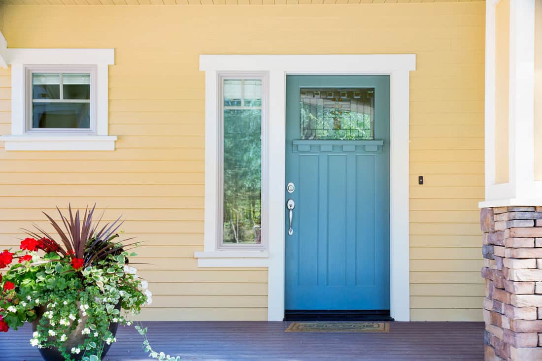 Gorgeous front porch with a blue front door with a small window on the side, Should Windows And Doors Be The Same Height?
