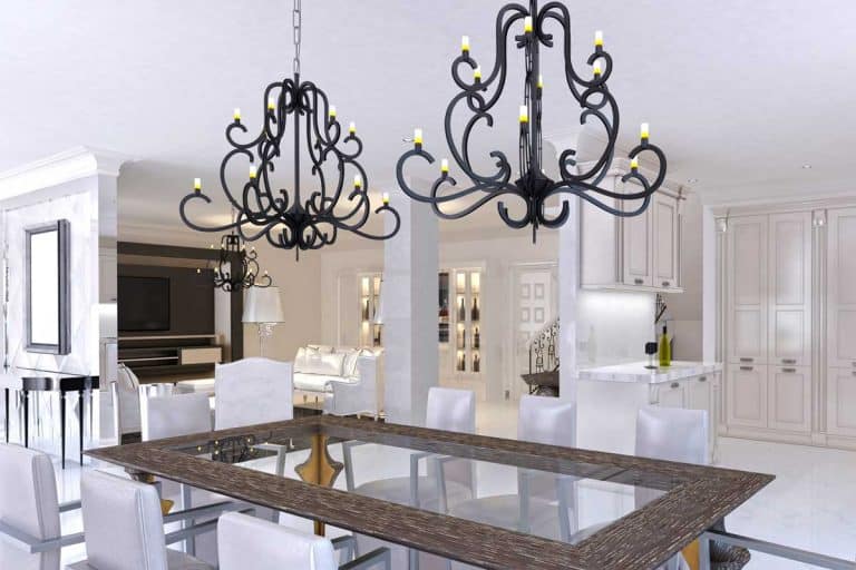 A luxurious dining room with dining table with two chadeliers and designer chairs, Can You Have Two Different Chandeliers In One Room?