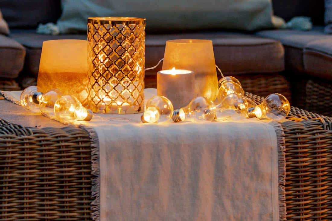 A warm summer night in the garden with trendy furniture, lights, lanterns and candles, 11 Awesome Candle holder Decor Ideas