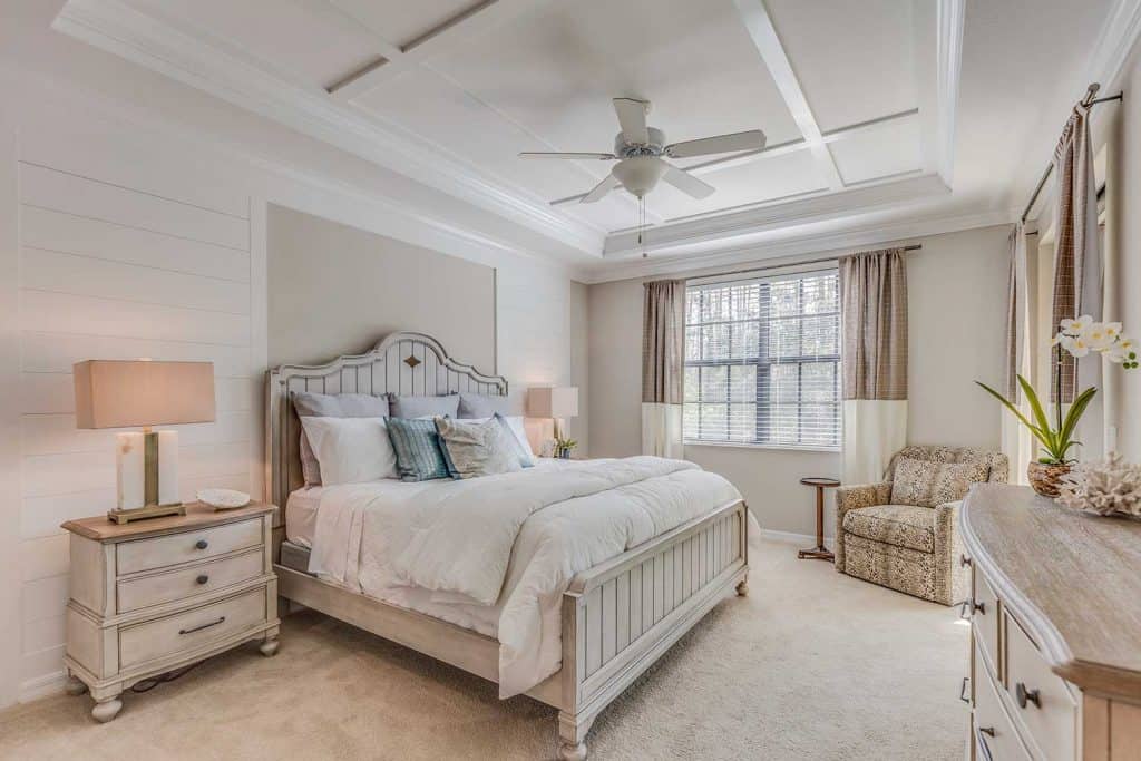 Beautifully decorated master bedroom with white and light brown tones