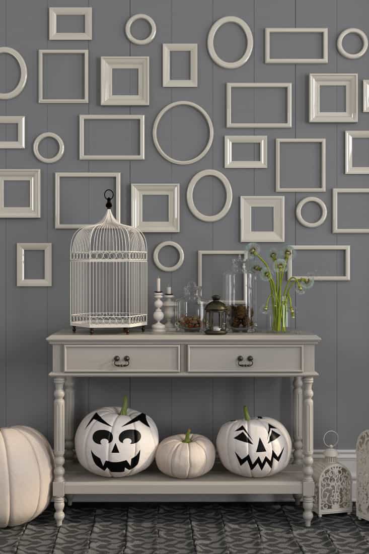 Beige table with decorations for Halloween, wider decorations above the console table