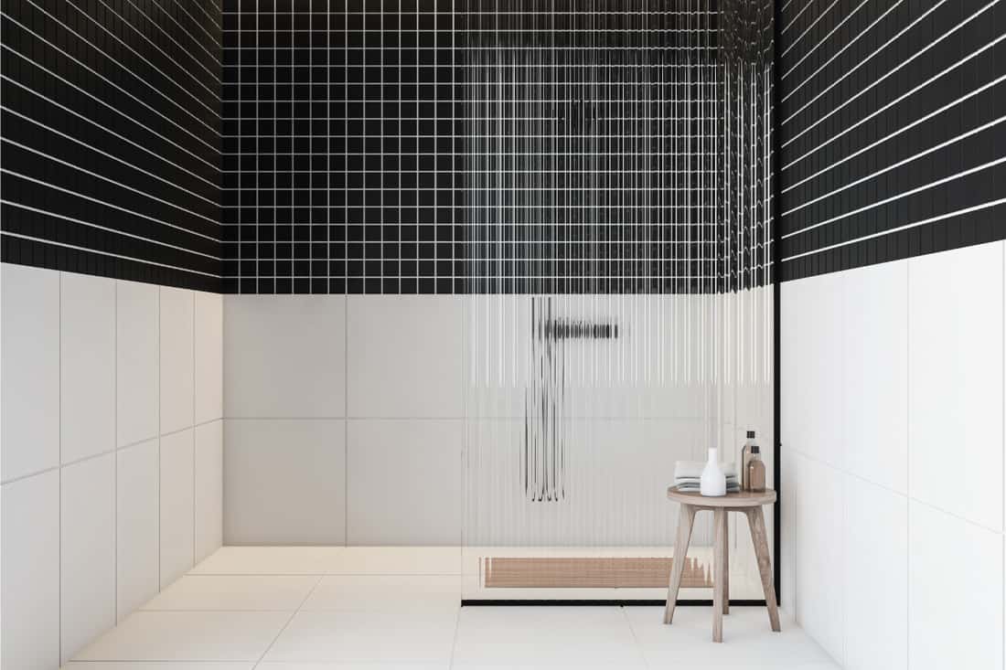 Black and white tiled shower in bathroom with shower bench, How Much Does A Shower Bench Cost?