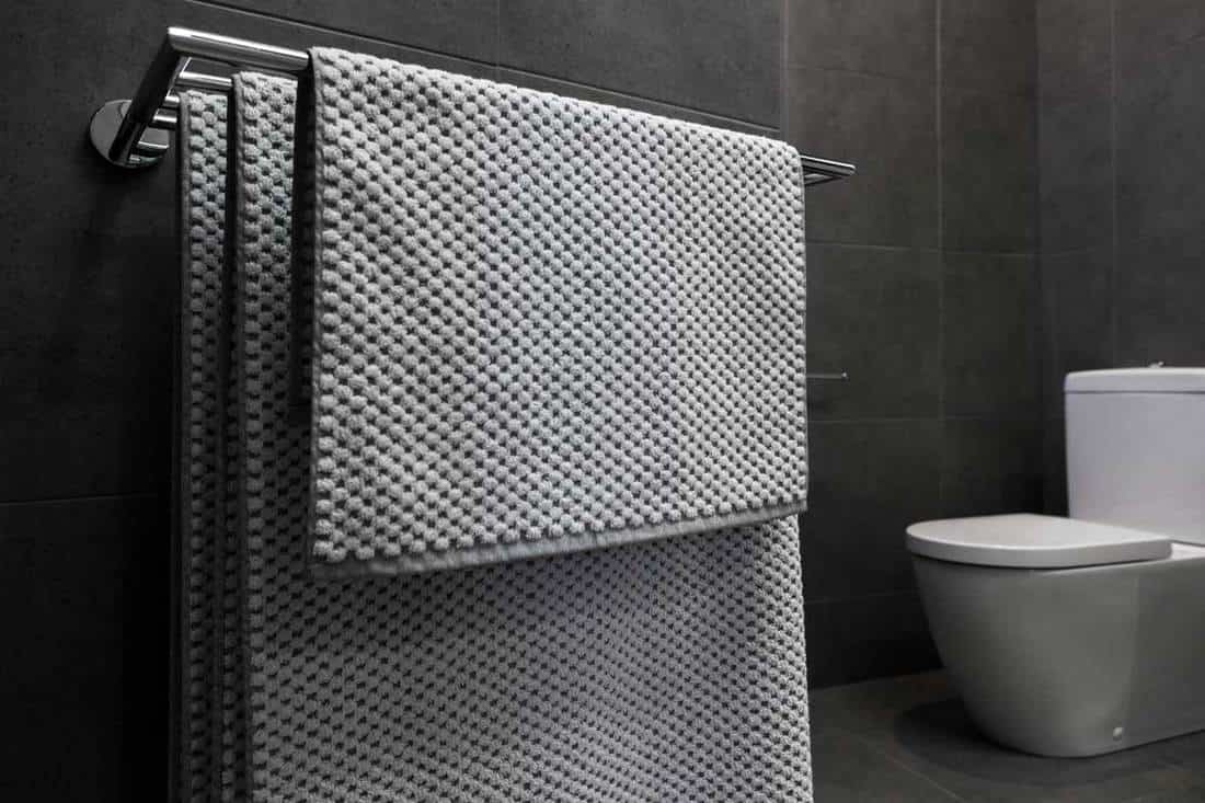 Close up of luxury bathroom towels in a monochrome ensuite bathroom, How High To Hang A Towel Bar?