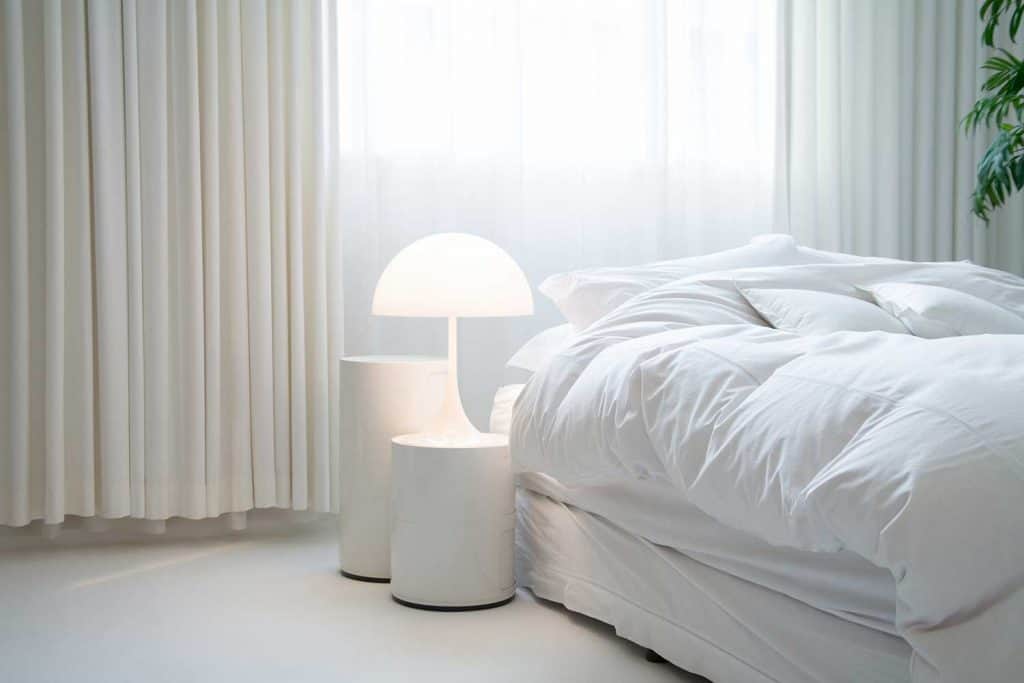 Cozy bed in white theme bedroom