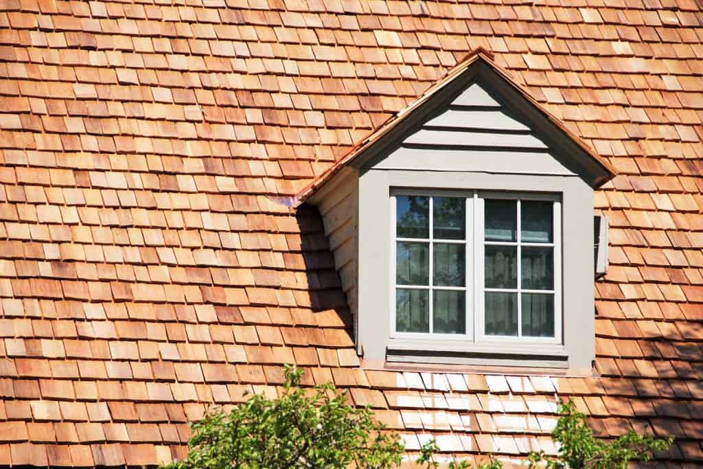 Dormer in roof of house with cedar shingles