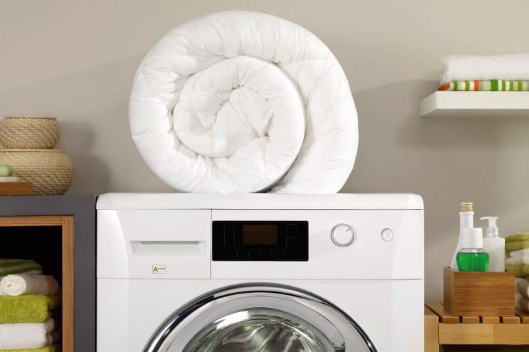 Folded newly washed white comforter in a laundry room, How To Make Comforter White Again